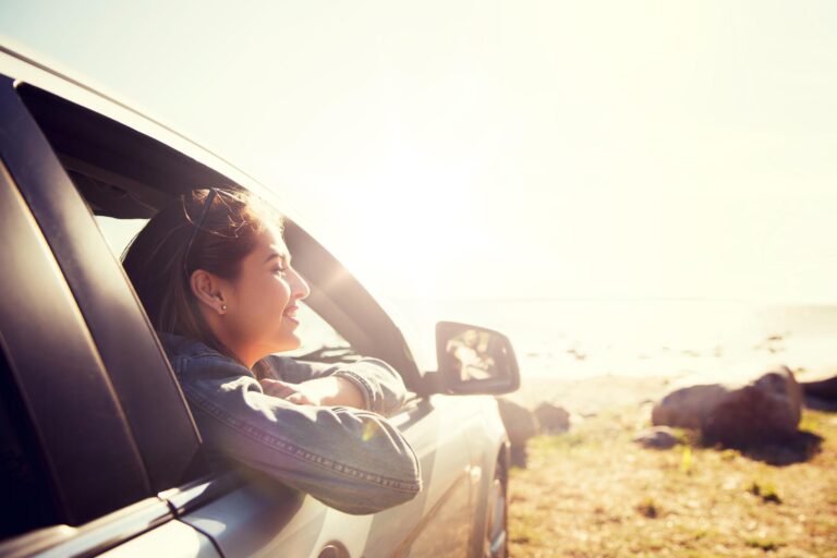 Happy woman inside a car