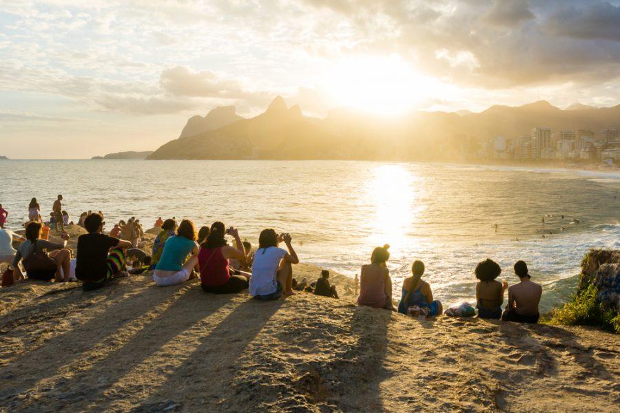 people gathered watching the sunset at arpoador rio de janeiro