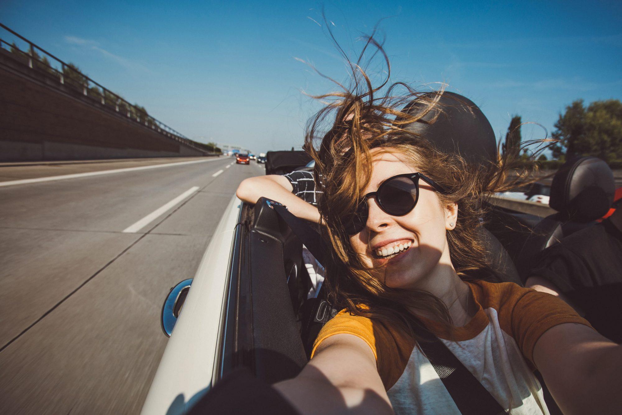 woman taking a selfie in a car