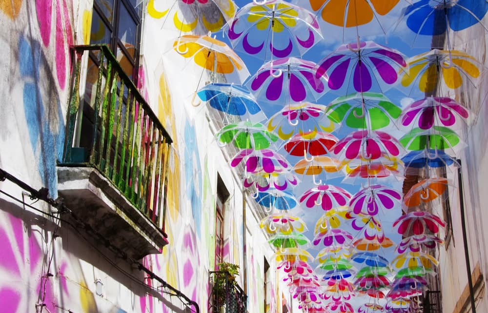 colorful umbrellas in the sky of beja in portugal