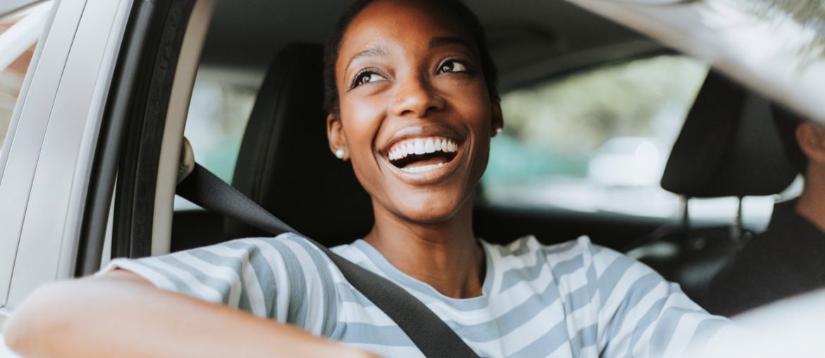mulher sorrindo dentro de um carro