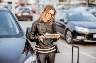 woman picking up a rental car at the airport