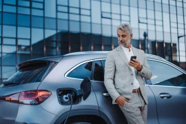 A business man with your eletric car in Europe