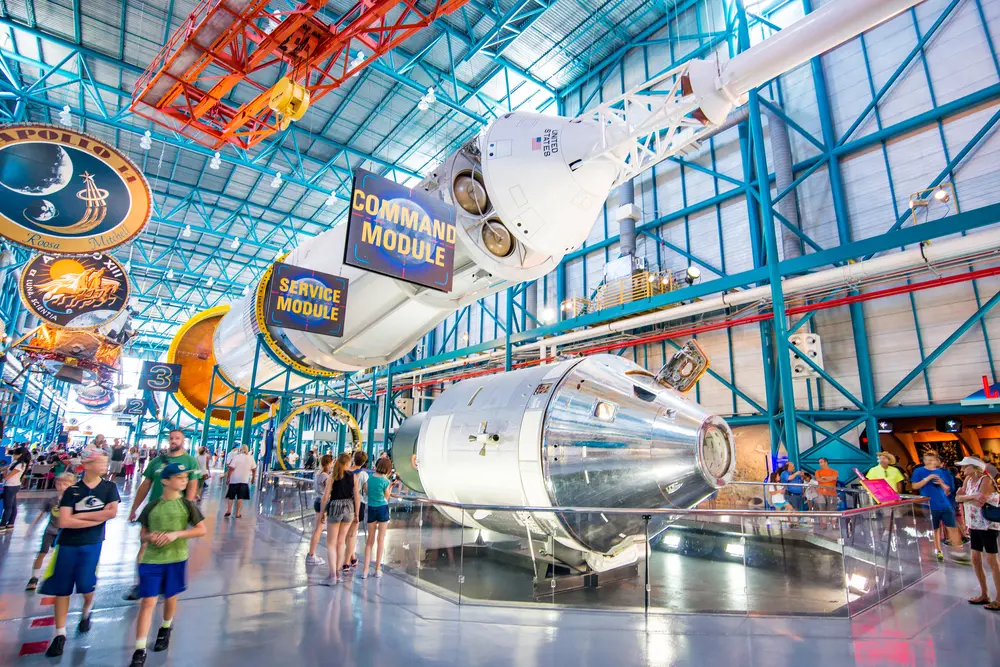 Inside view of the NASA Kennedy Space Center Visitor Complex, some of its visitors and rockets.