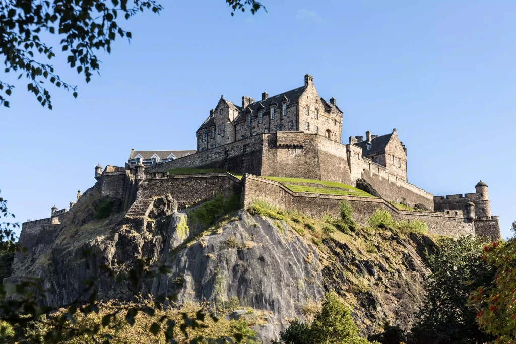 Photo of Edinburgh Castle, a historic fortress perched atop Castle Rock, a volcanic plug overlooking the city.