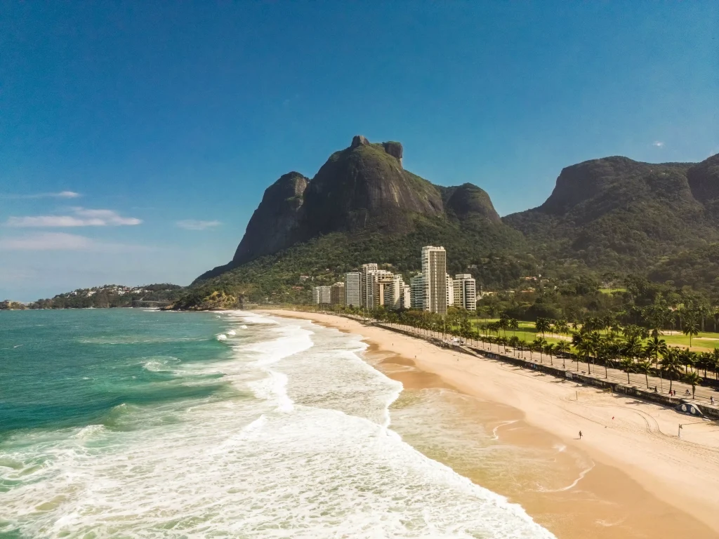 The photo captures São Conrado beach, sand, the ocean, and Pedra da Gávea in the background.