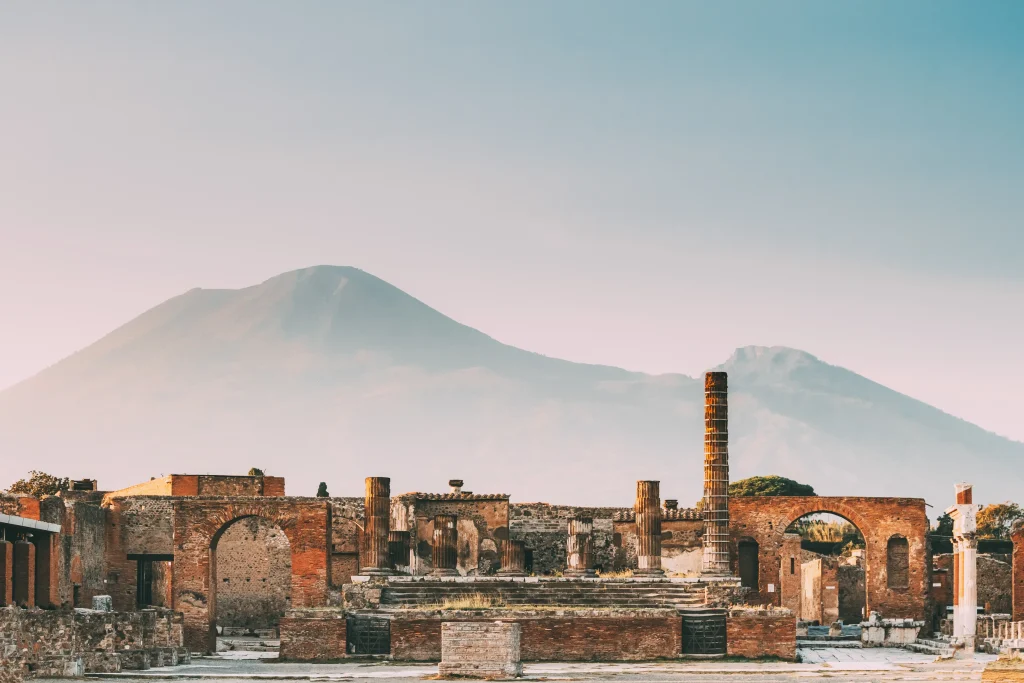 Pompeii's ruins, shadowed by Mount Vesuvius.
